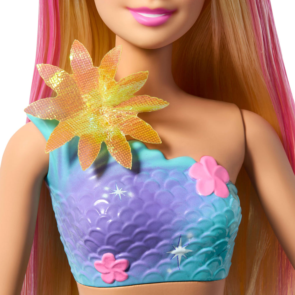 Barbie Flower Magic Mermaid doll’s iridescent flowers shimmer during pretend garden adventures.