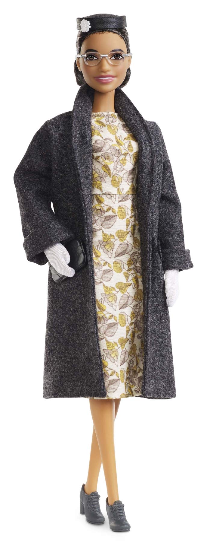 Barbie Inspiring Women Rosa Parks doll in floral dress and coat for display.