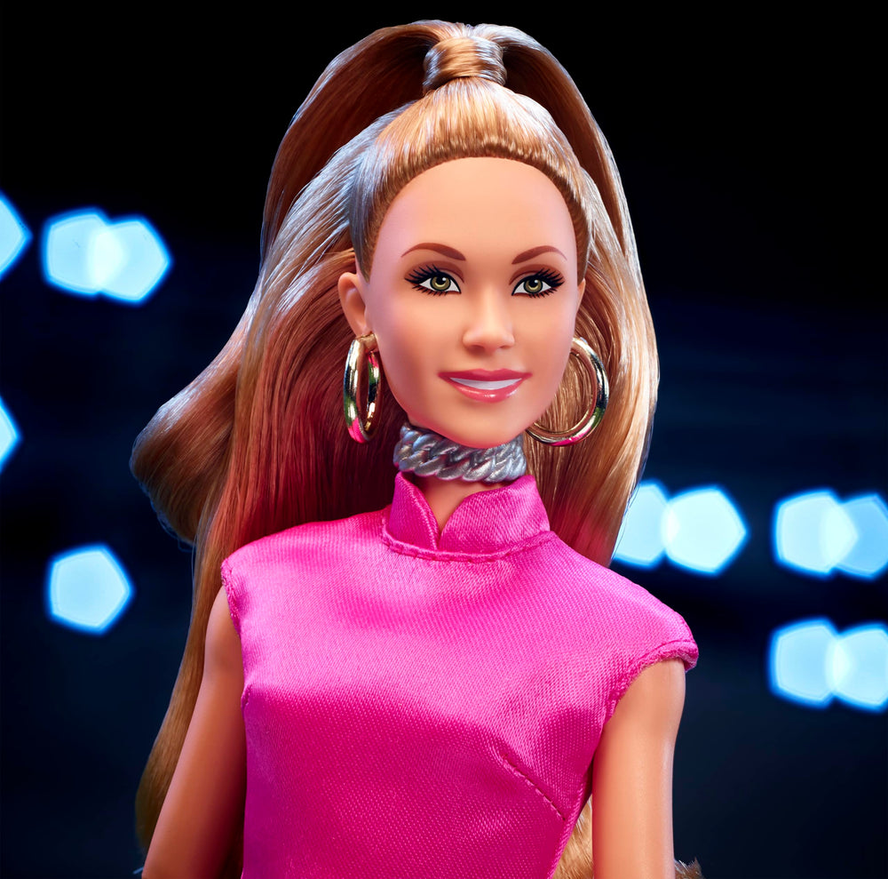 Barbie Keeley wearing golden hoops and pink clutch, ready for photo-ready posing.