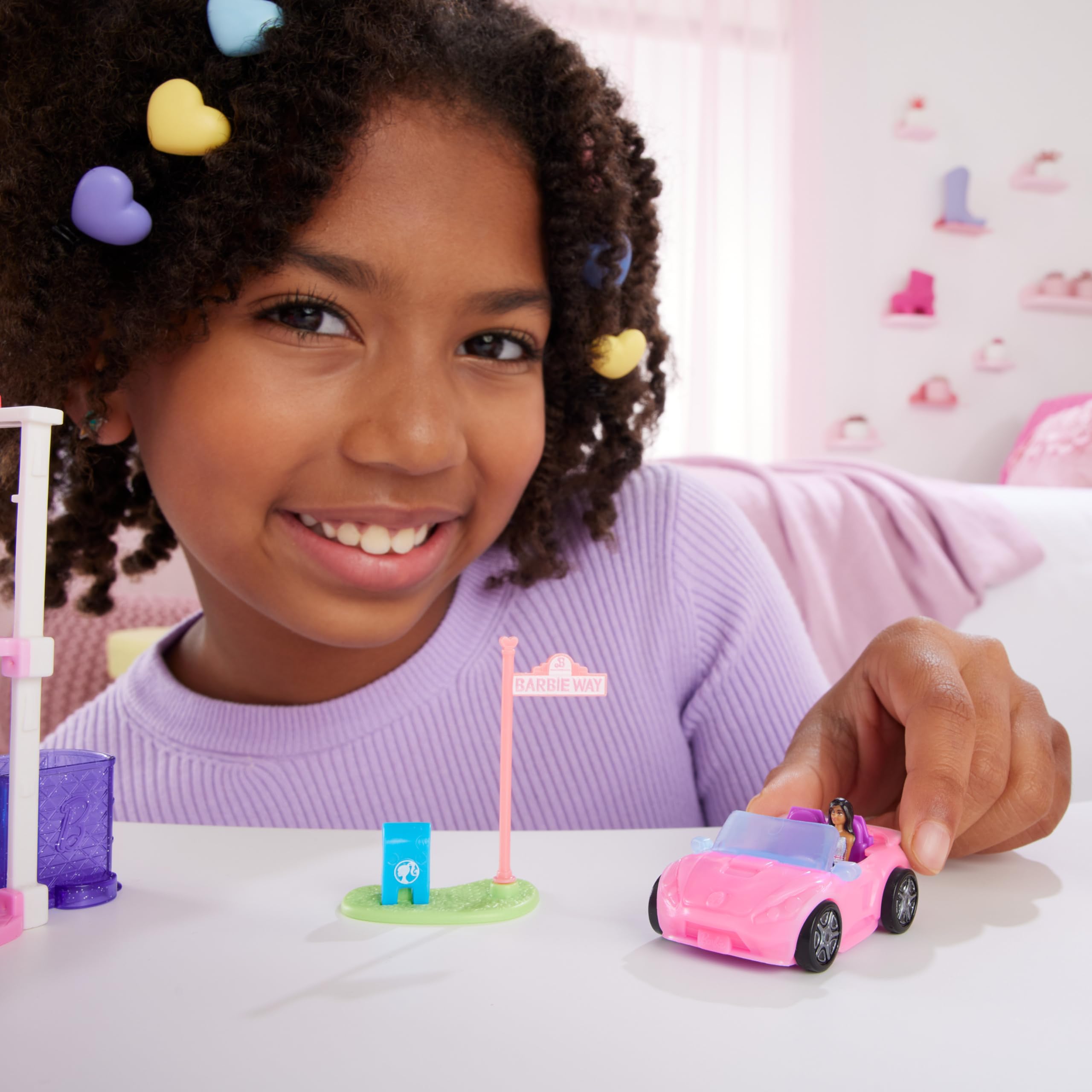 Barbie Mini BarbieLand 1.5-inch doll seated in the driver's seat for mini adventures