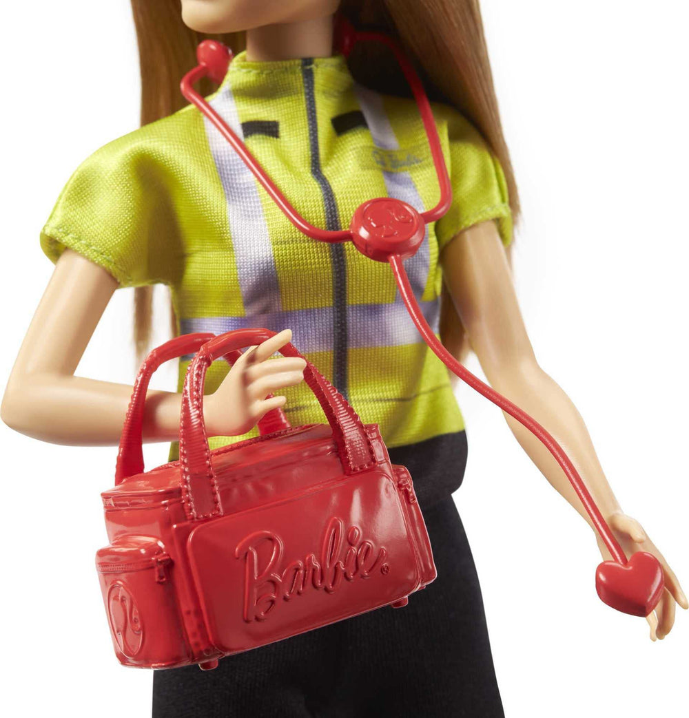 Barbie paramedic doll with medical bag enhances pretend patient care.