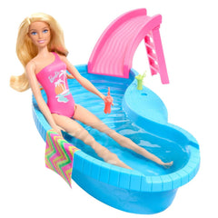 Barbie climbs the ladder and slides into the pool for splashy play