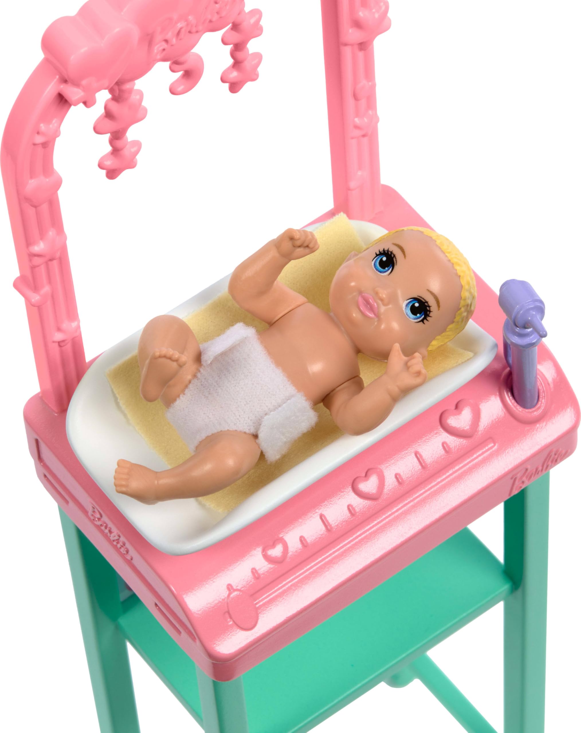 Shelf with baby bottle and accessories supports interactive caregiving scenes.