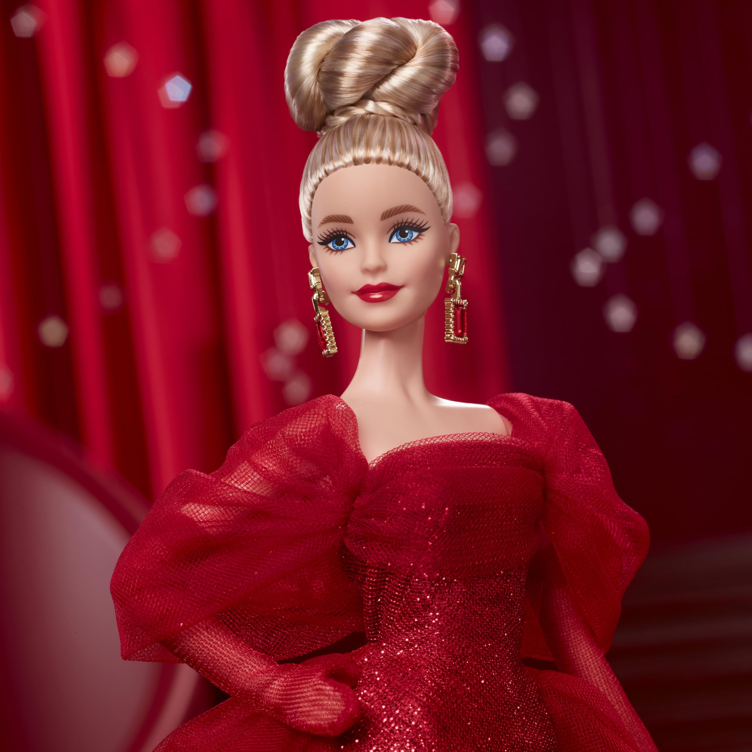 Barbie Signature doll with drop earrings and golden M adds classic charm.