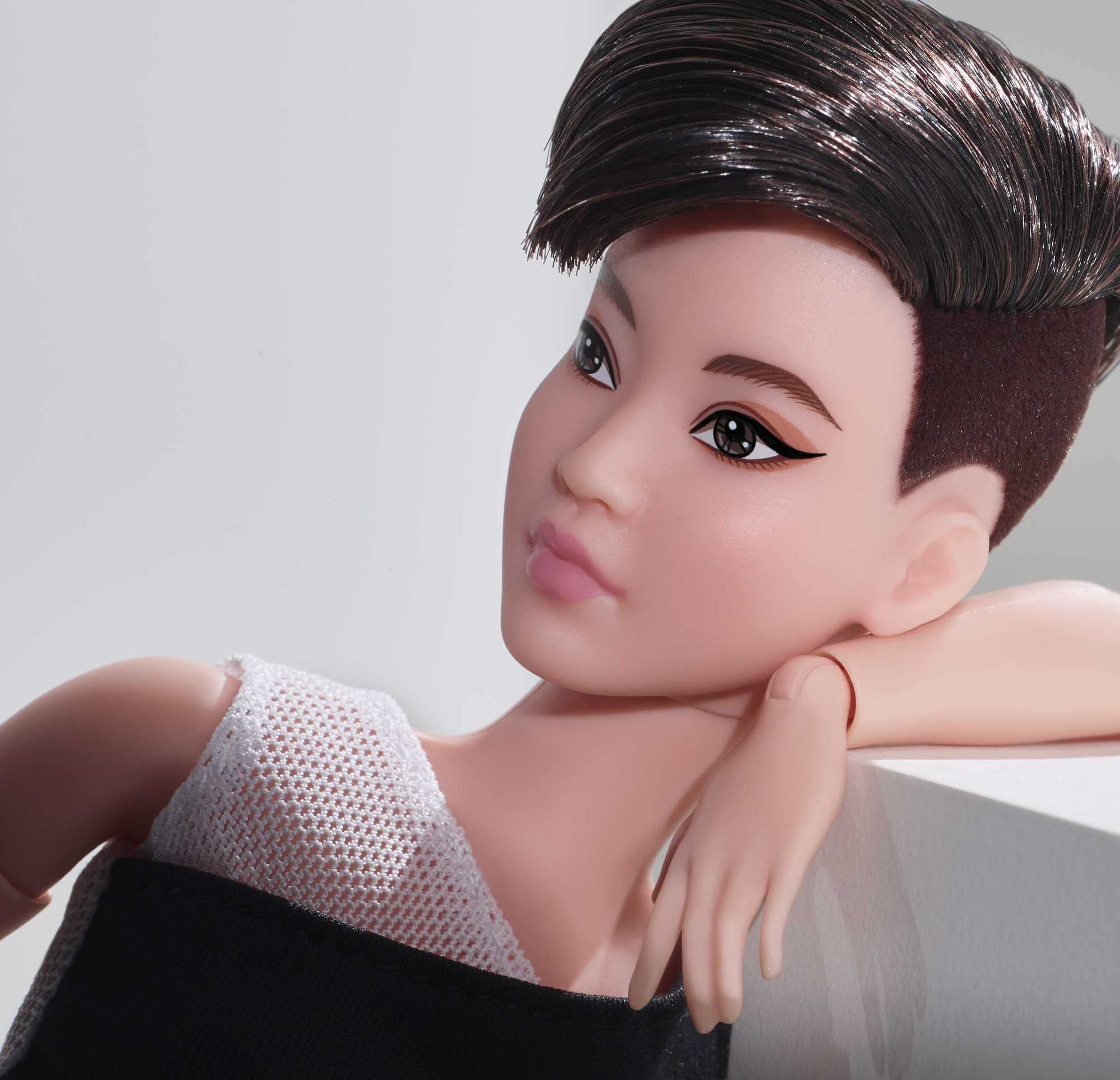 Barbie Signature Looks doll wears a high-waisted midi skirt for chic display.