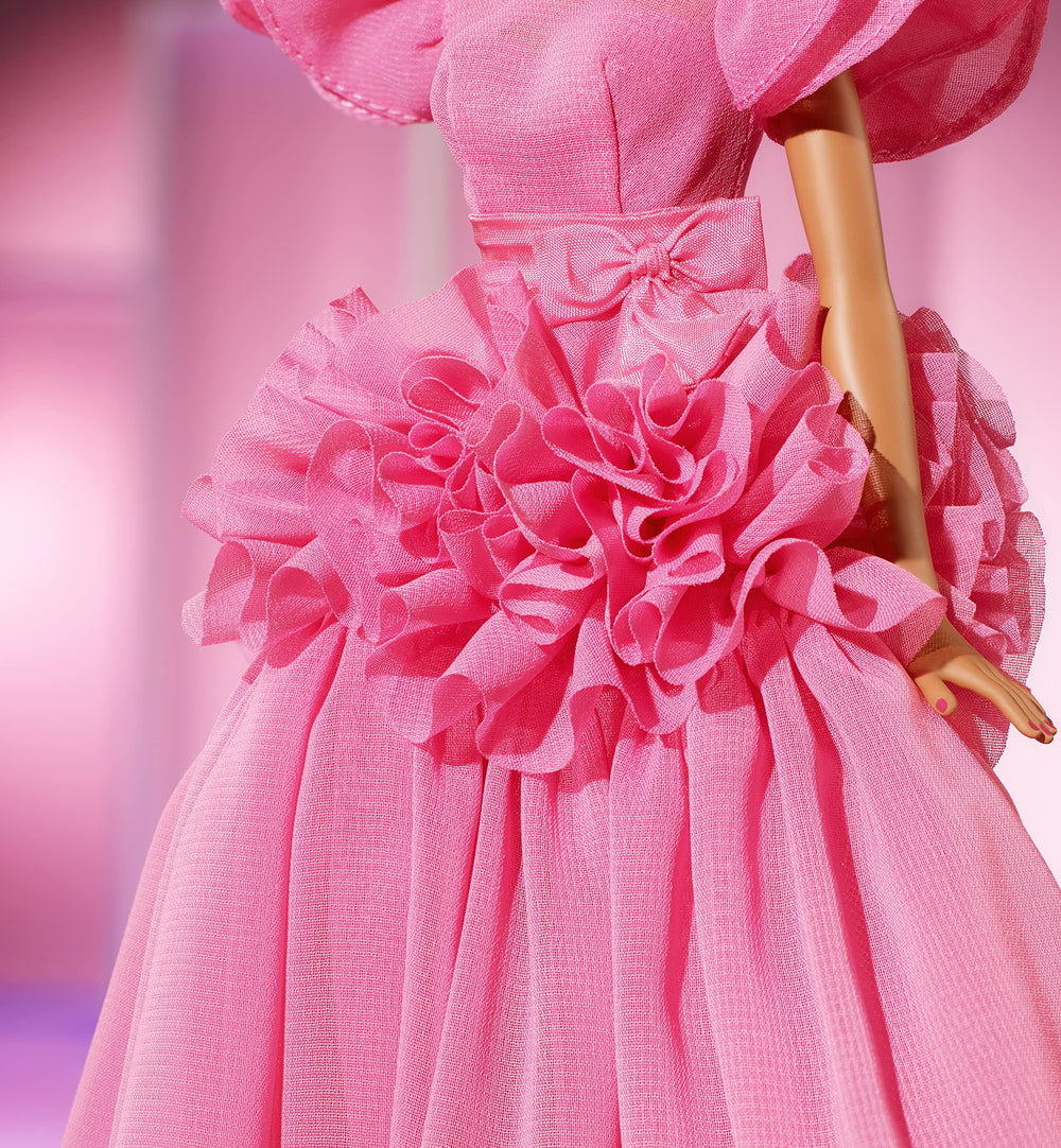 Barbie top-knot with curls creates a chic, photogenic hairstyle.