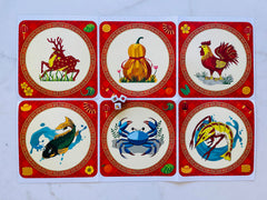 Bau Cua Ca Cop game mat top view with traditional icons for family fun