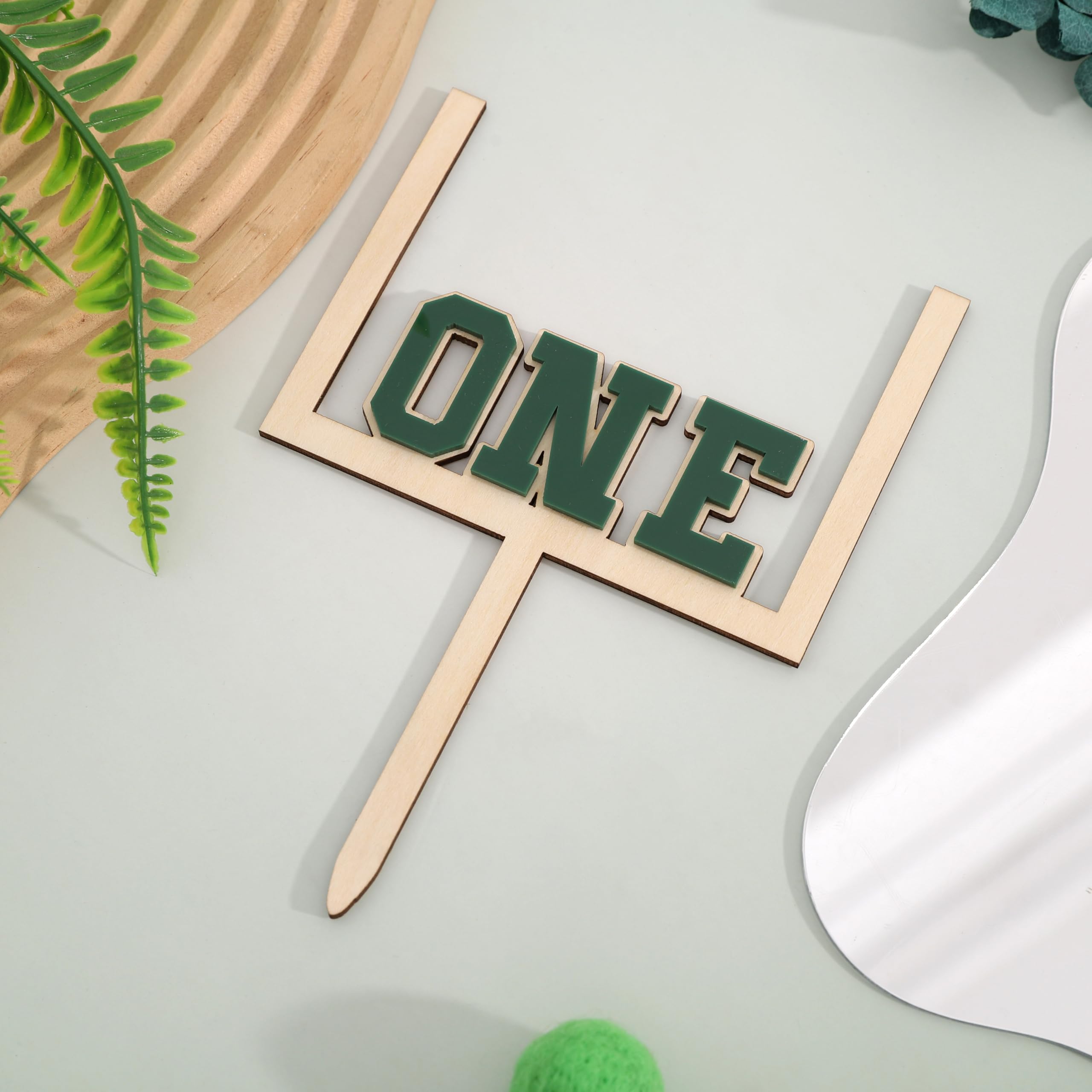 BEADED wood-acrylic football topper provides versatile cake or table centerpiece.