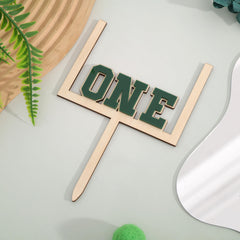 BEADED wood-acrylic football topper provides versatile cake or table centerpiece.