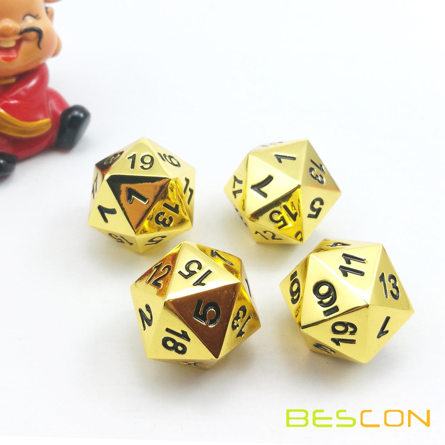 Bescon golden D20s on a leather mat, ideal for long campaigns
