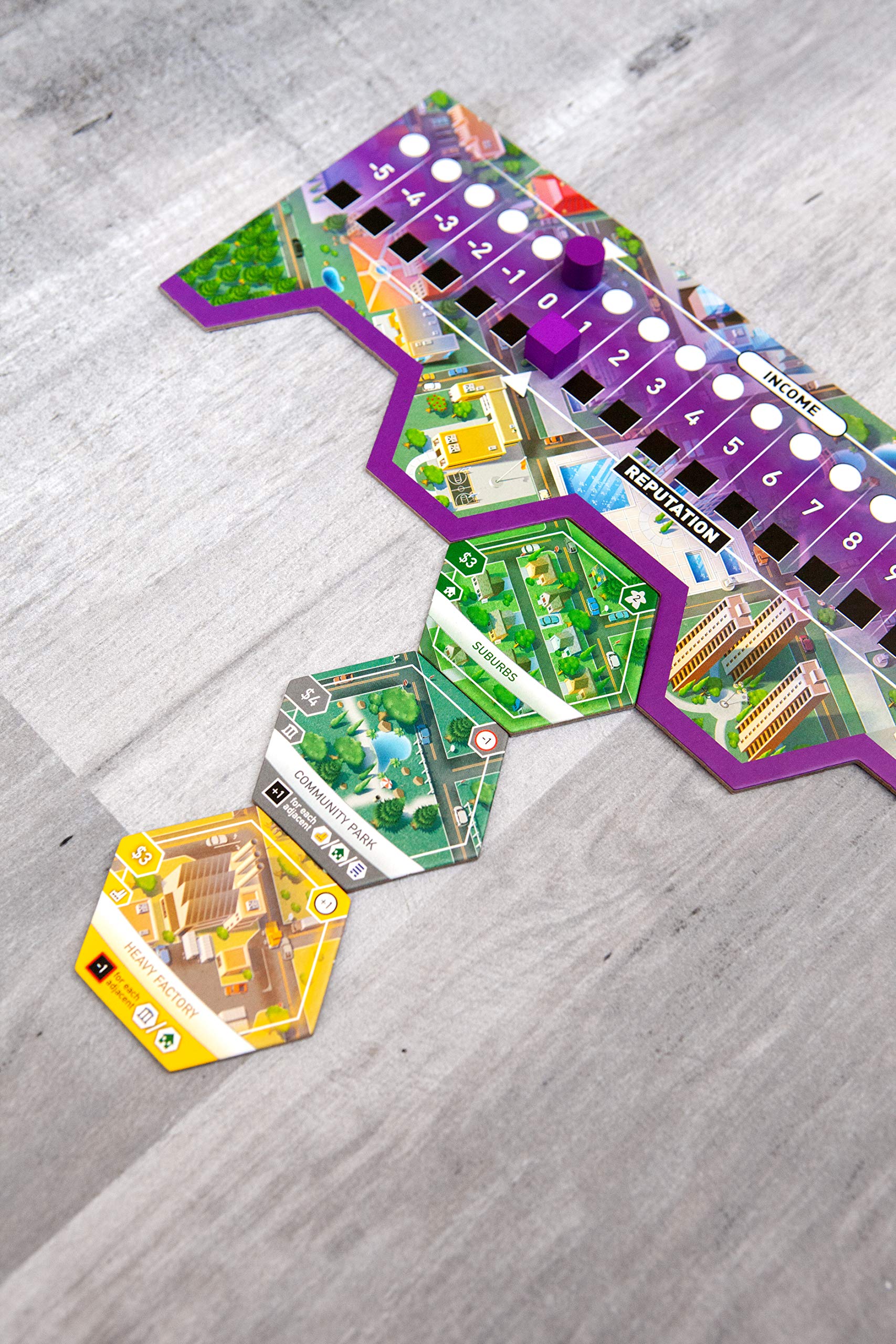 Bezier Games Suburbia population tokens close-up illustrating population growth tracking