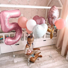 Biapian baby shower decor with number 2 balloon adding soft pink highlight.