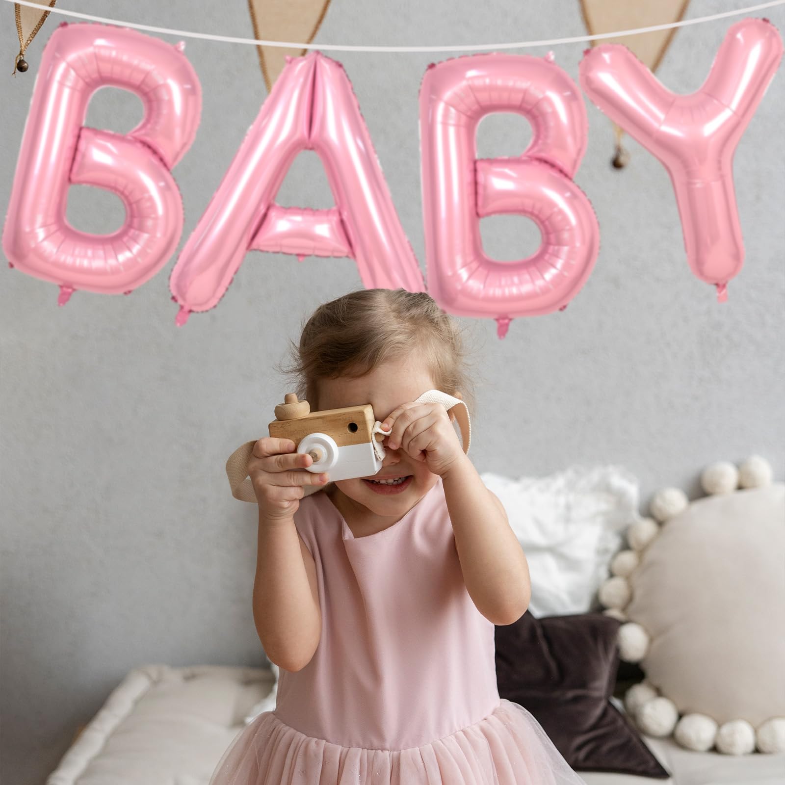 Biapian gender reveal setup with towering pink BABY letters.