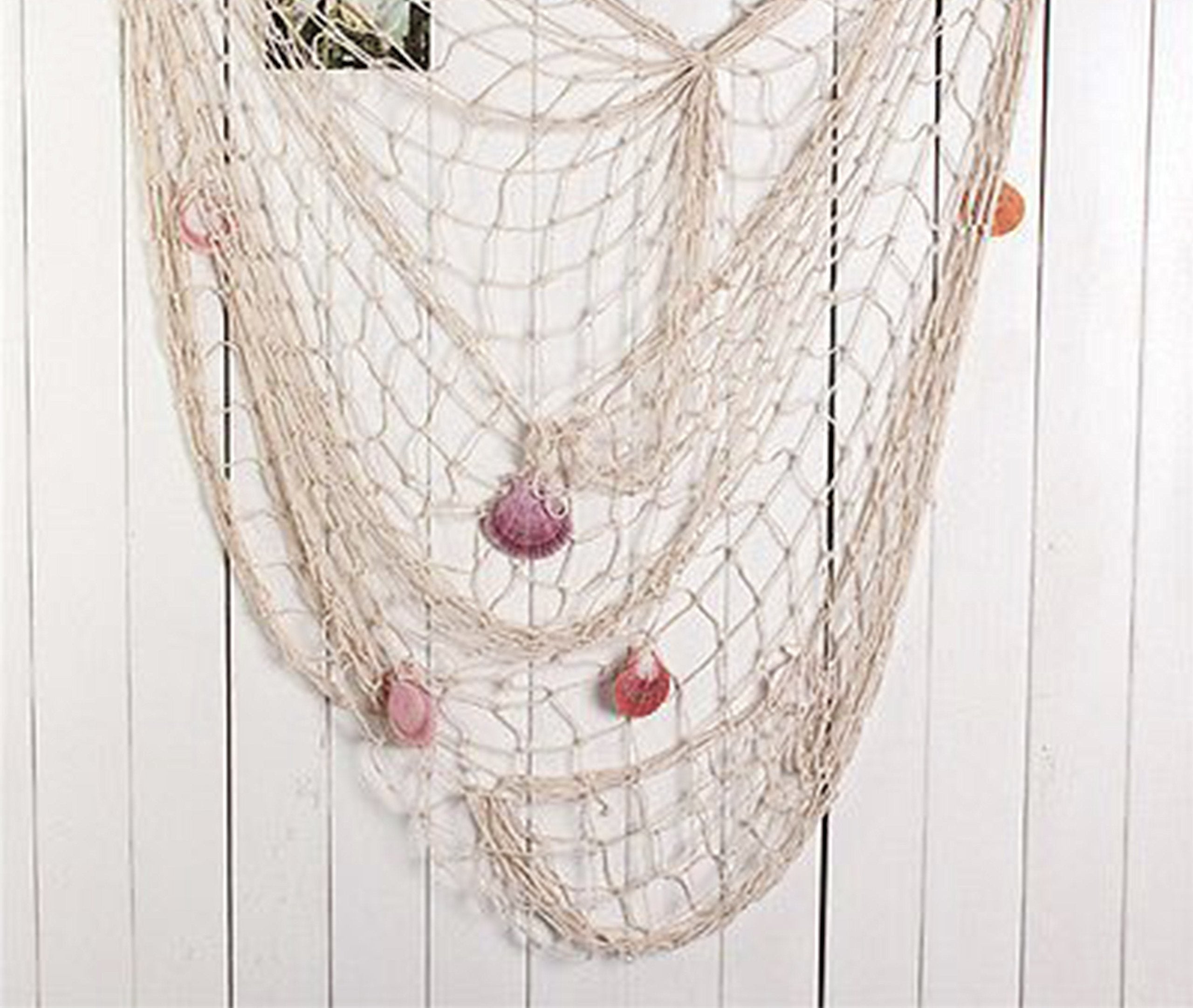 Big Mo's Toys beach party setup gains depth with natural fish net draping.