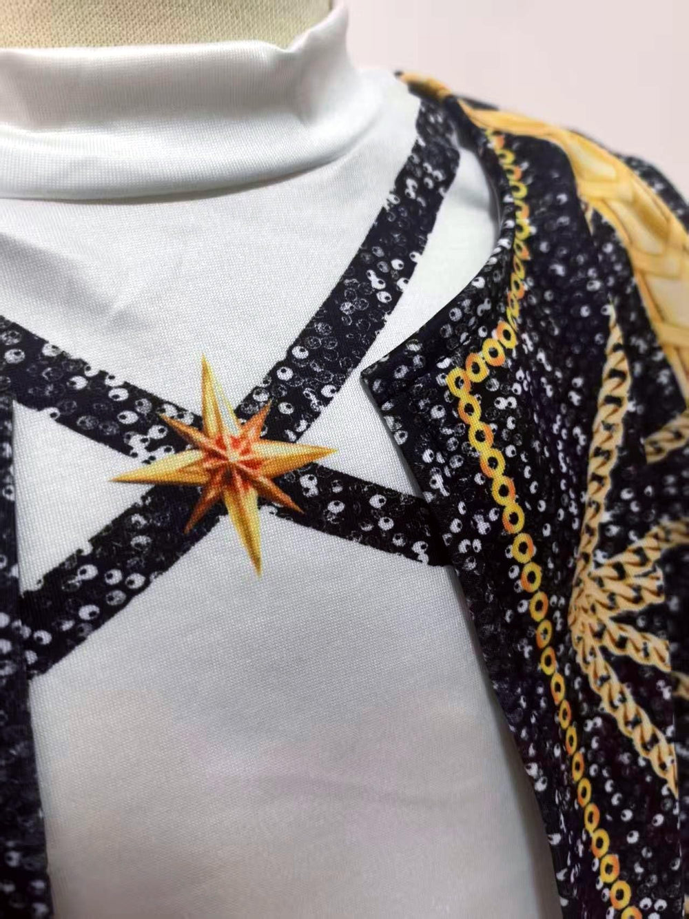 Binbo Rumi golden costume top close-up featuring sequin straps and star detail for chic layering