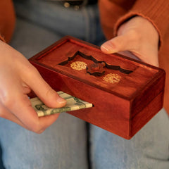 Bits and Pieces Japanese puzzle box reveals a hidden compartment for small keepsakes.