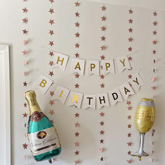 Blukey white banner with gold letters stands out in party photos.