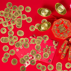 Red string arranged coins for festive charm.