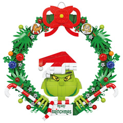 Brickcraft Grinch Wreath hanging on wall showcases festive brick-built charm.
