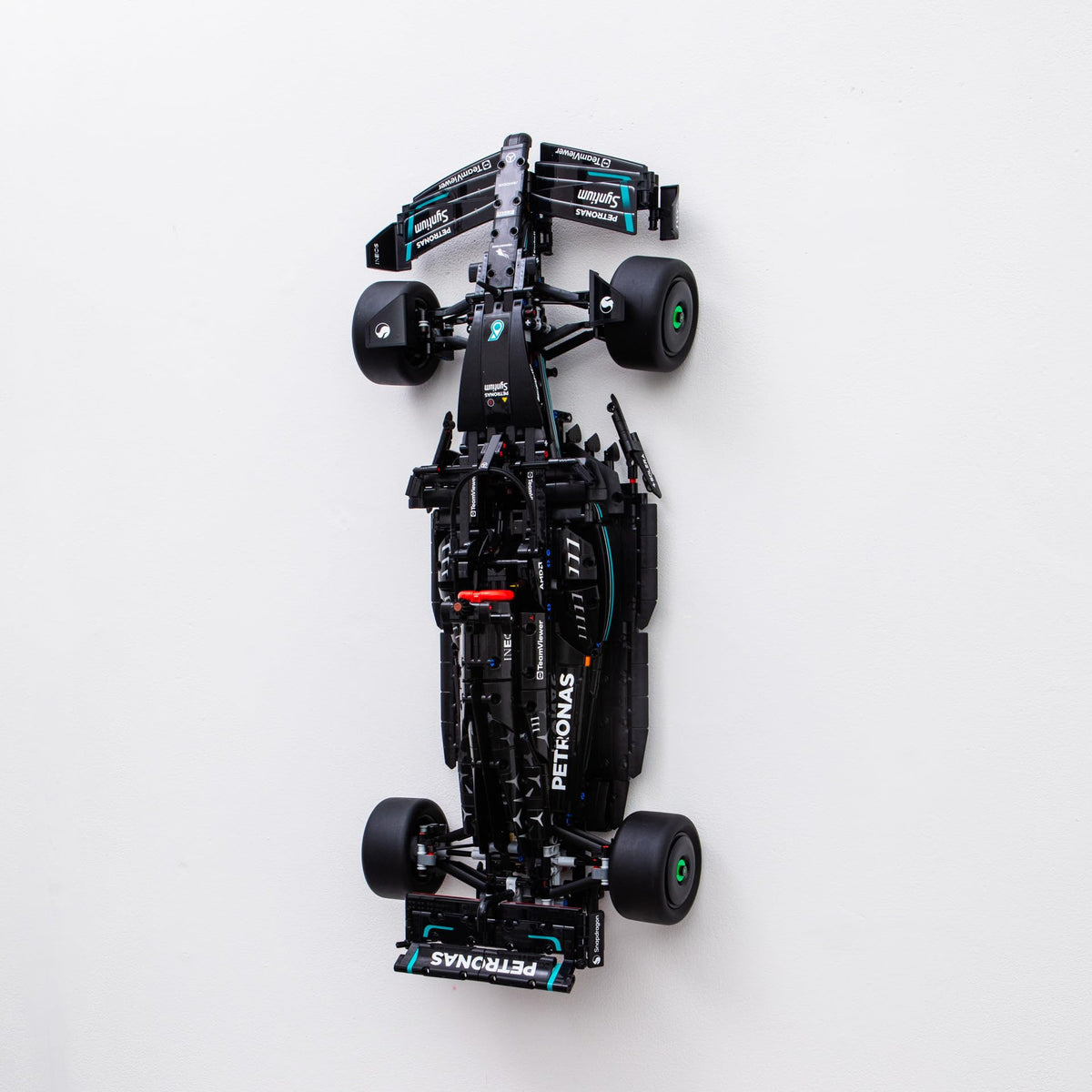 Brickify wall mount securely displays the 42171 Mercedes F1 model on the wall.