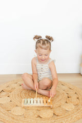 Brooklyn Neutral Xylophone decor and learning toy in a playroom setup.