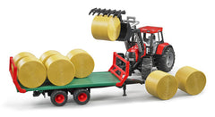 Bruder 02220 trailer loaded with eight round hay bales for farm play scenarios.