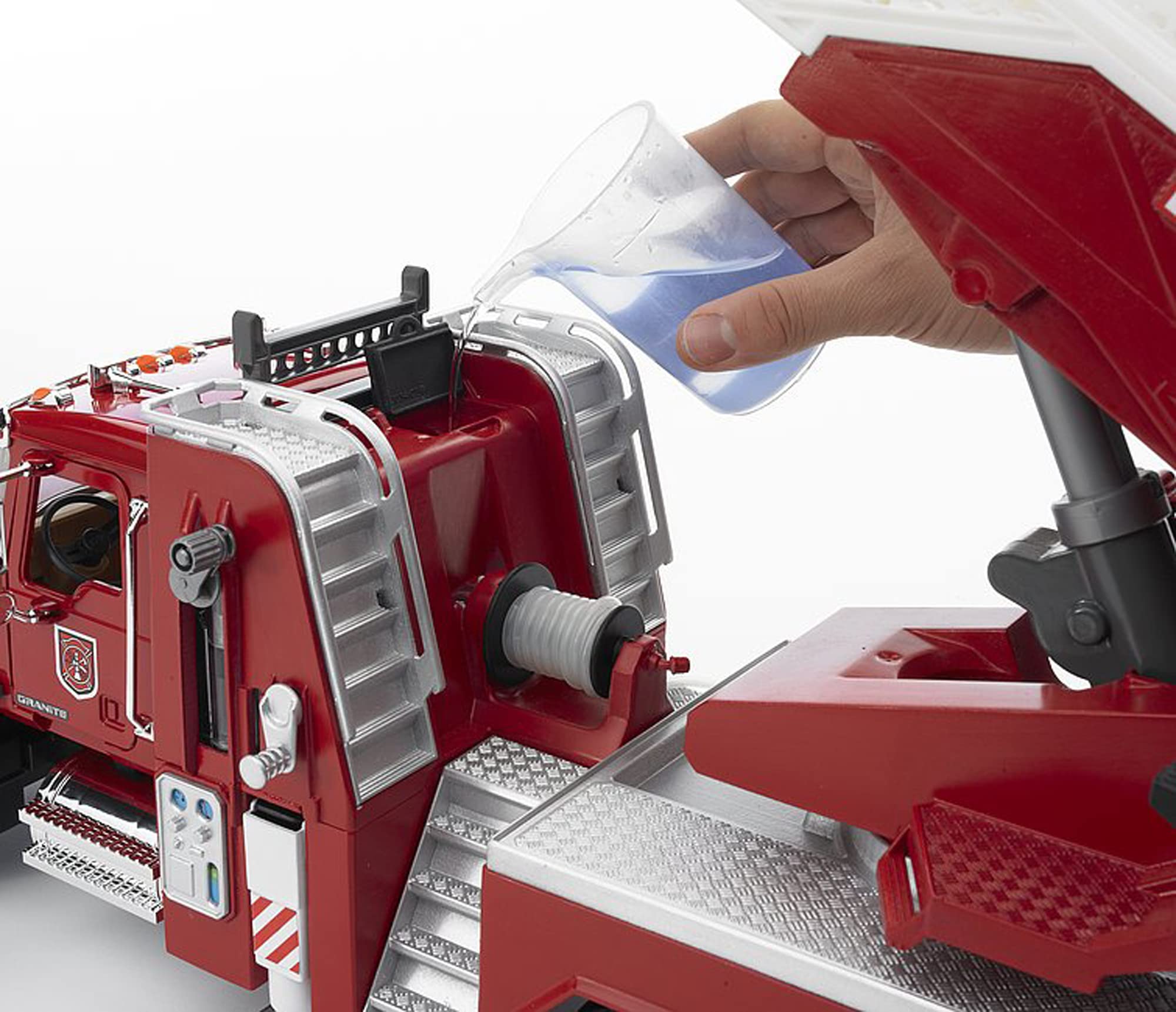 Bruder Mack Granite fire engine opening hood reveals chrome-like detailing.
