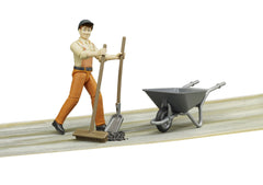 Bruder municipal worker figure with wheelbarrow enhances cleanup and site maintenance play.