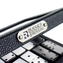 Classic black Bucher&Rossini domino tiles spread on a table for play