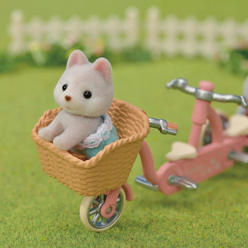 Calico Critters dollhouse accessories and village backdrop for creative play.