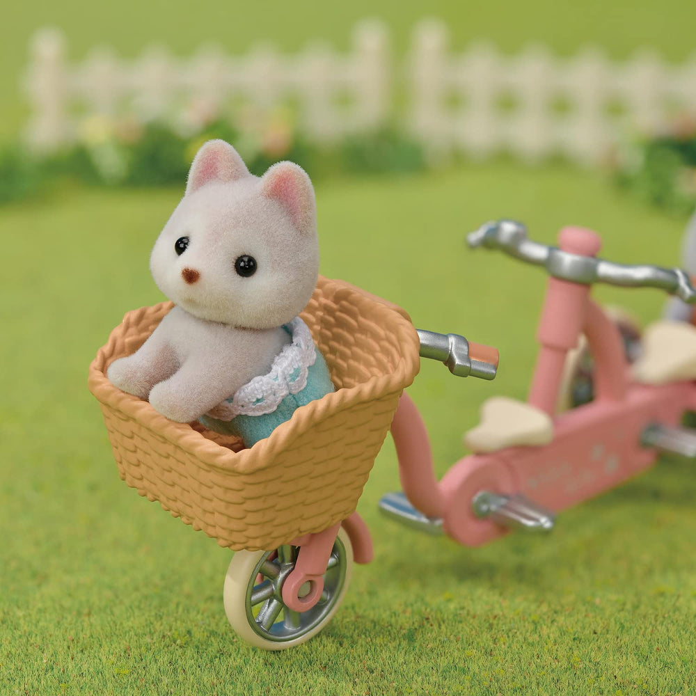 Calico Critters dollhouse accessories and village backdrop for creative play.