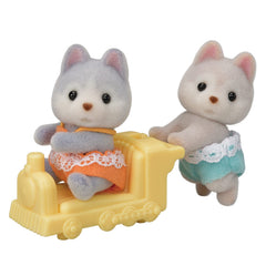 Calico Critters Husky Twins with pushcart for imaginative outdoor play.
