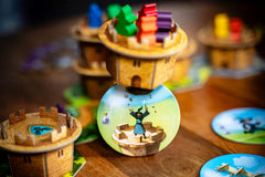 Capstone Games Wandering Towers starting player token signals game flow.