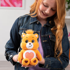 Care Bears Tenderheart Bear 9-inch plush is the perfect travel buddy for adventures.