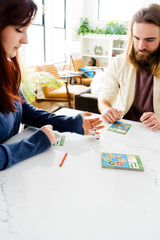 CATAN Dice Game family night setup shown around a table.