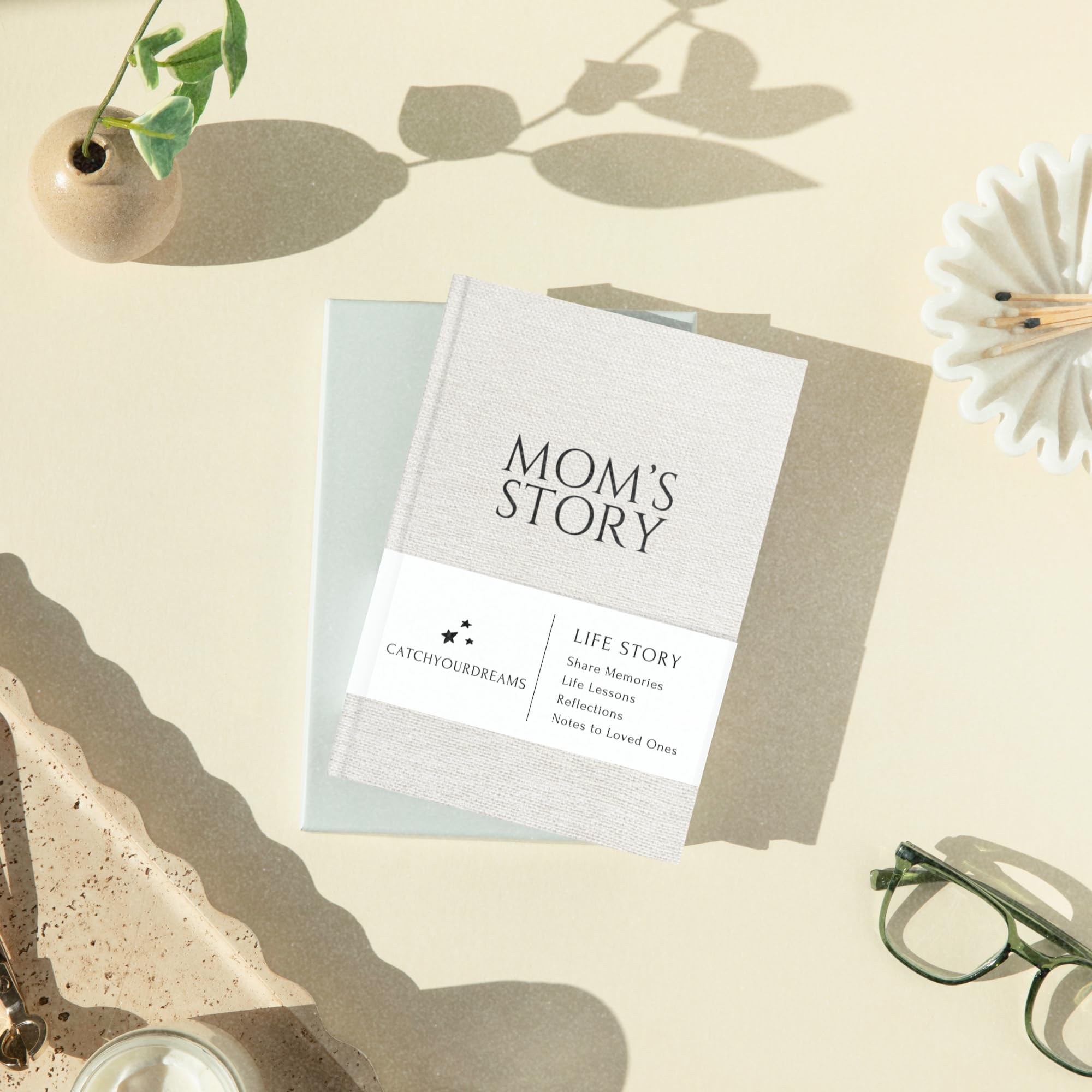 CATCHYOURDREAMS Journal stacked with keepsakes signals lasting legacy.