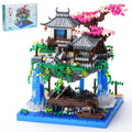 CAXIMSY Cherry Blossom Bonsai Tree House assembly with vibrant bricks and intricate details.