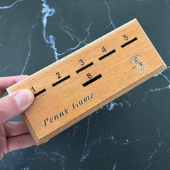 CBLKUS Penny Game dice roll, suspense builds as players plan moves.