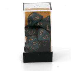 Dusty green copper dice set on table shows uniform size.