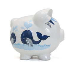 Nursery decor shot featuring Child to Cherish Piggy Bank in blue double whale design