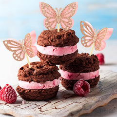 Chinco pink glitter butterflies rise above cupcakes with romantic flair.