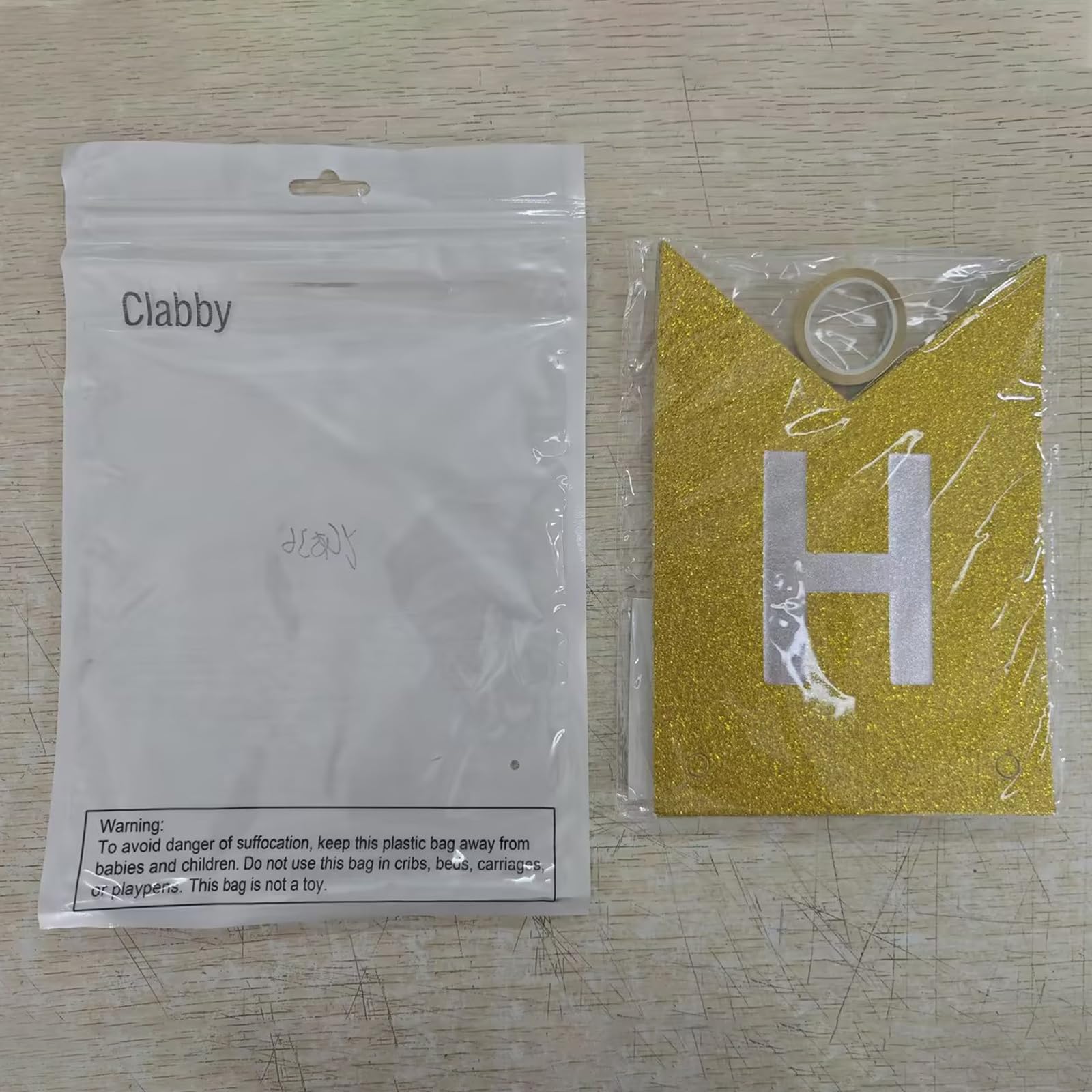 Clabby glitter gold banner wall display enhancing party ambiance.