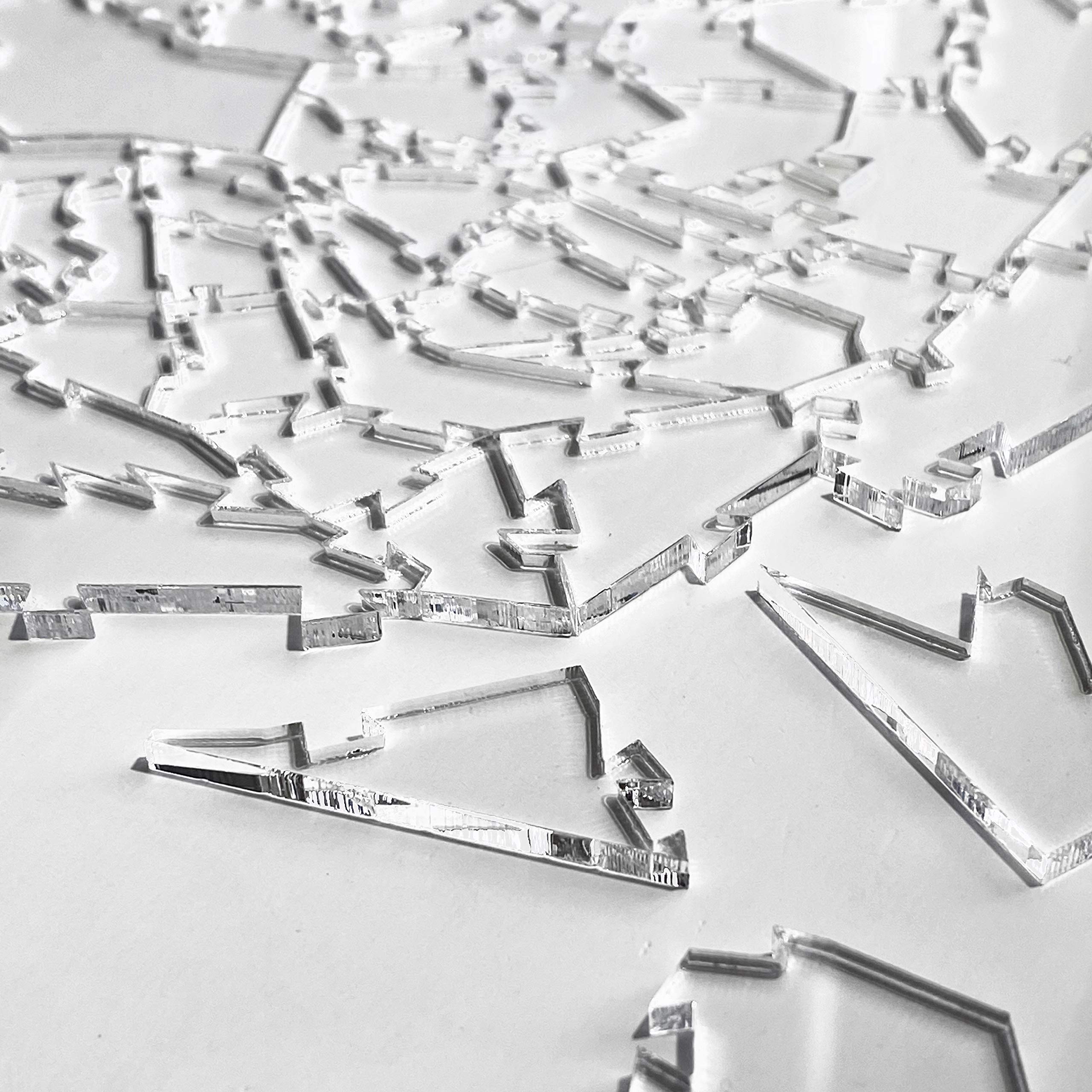 Finished CM Originals Broken Glass Puzzle displays transparent silhouettes against a neutral backdrop.