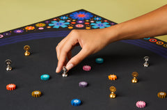 CMYK Lacuna board game mystical geometry art close-up with colorful tokens.