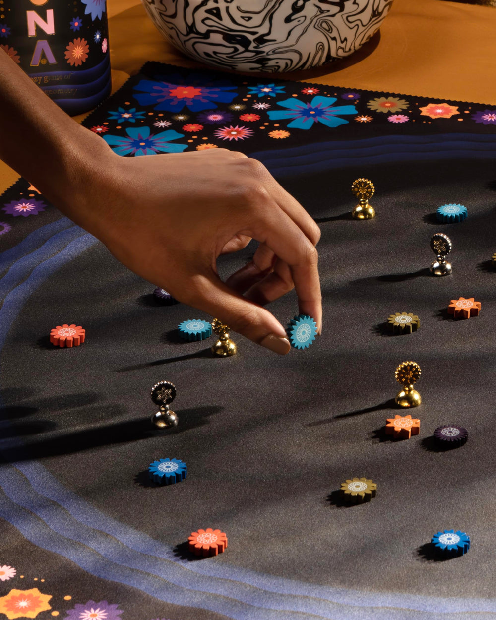 CMYK Lacuna board game play scene with two players and calm focus.