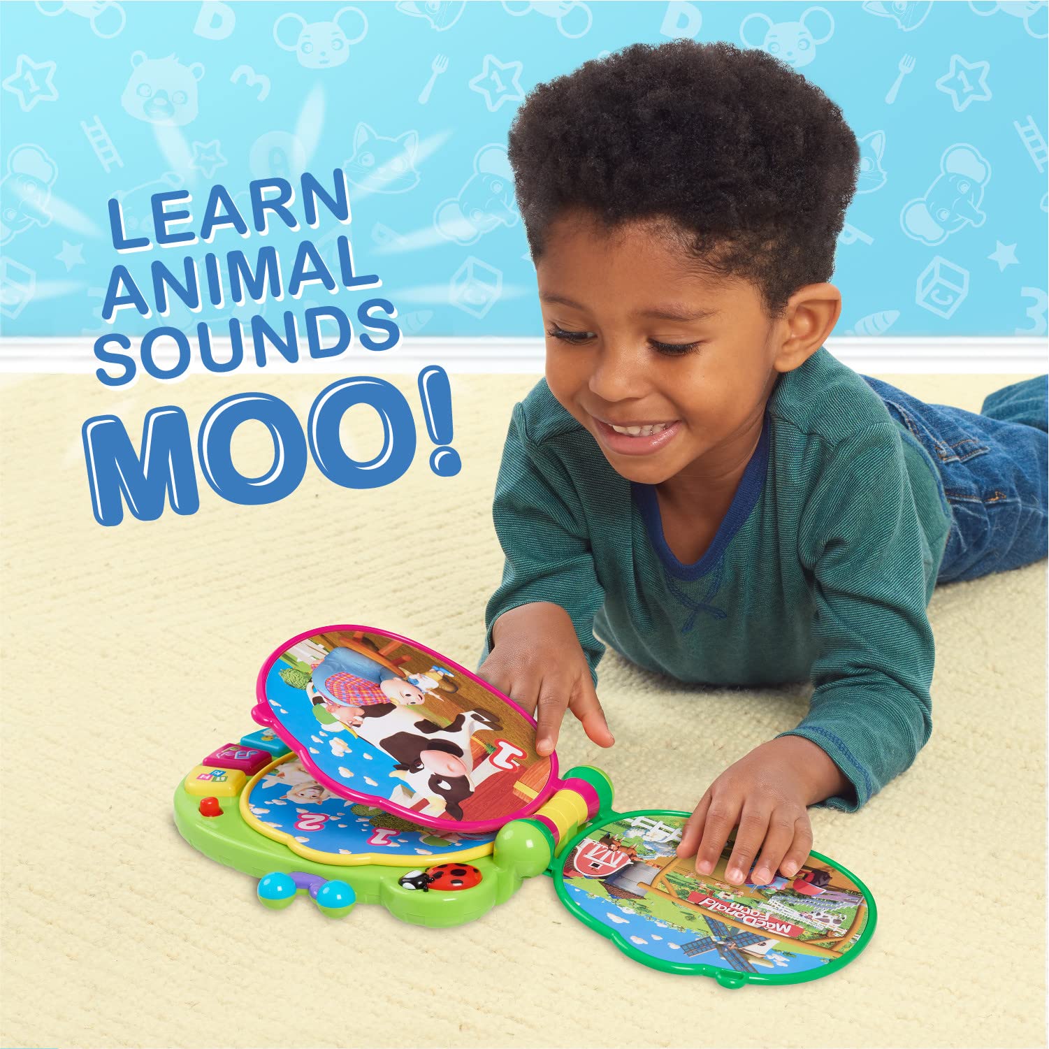 Toddler holding the CoComelon Learning Book during interactive play.