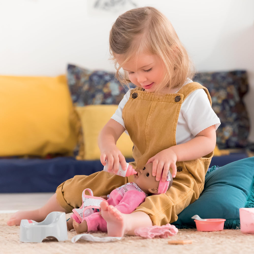 Corolle baby doll care complete set arranged, all essentials ready for nurturing play.