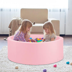 Kids playing with COZYTRAUM pink ball pit indoors