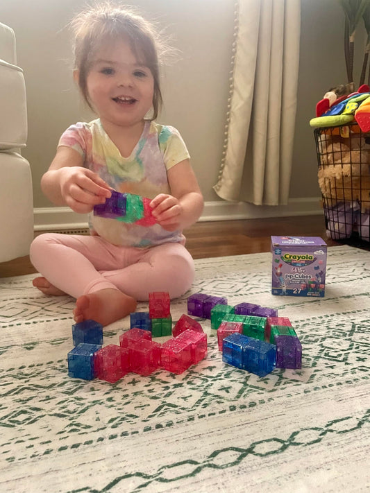 CreateOn Crayola Glitter PIP Cubes travel scene demonstrates portable STEM fun on the go.