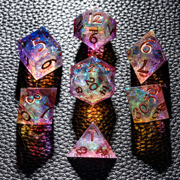 CRITALLIC 7-piece DND dice set close-up highlights transparent sharp edges and vivid purple-orange hues.